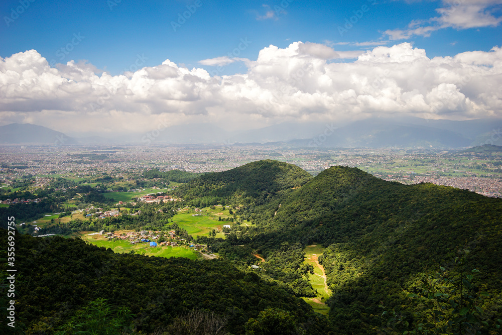 View of Kathmandu valley with green forest and clouds from a hill in Bhaktapur.