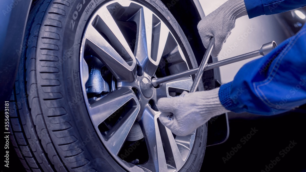 Fototapeta premium Car repairs. Removing the wheel. Replacing wheels.