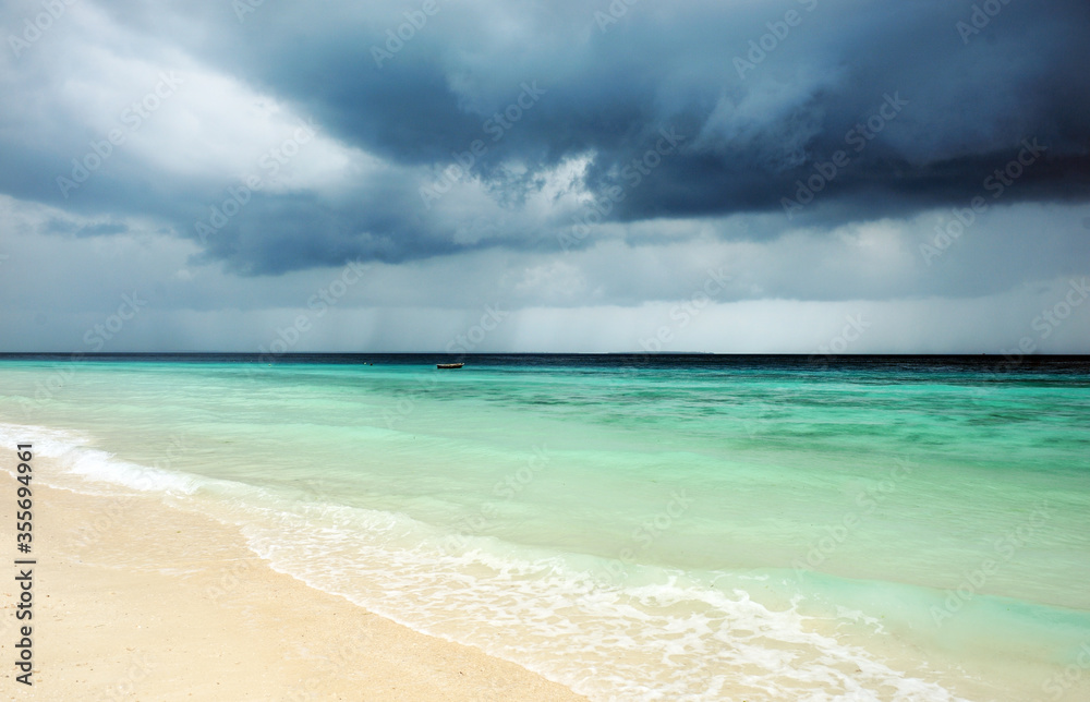 Cloudy landscape of Indian ocean sandy beach before the storm.ZANZIBAR - TANZANIA Cloudy landscape of Indian ocean sandy beach before the storm.ZANZIBAR - TANZANIA
