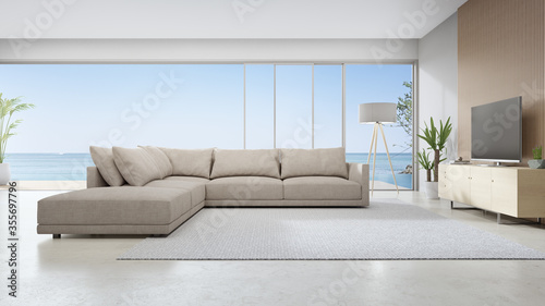 Fotografía Travertine floor of large living room and sofa near TV in modern beach house or luxury pool villa
