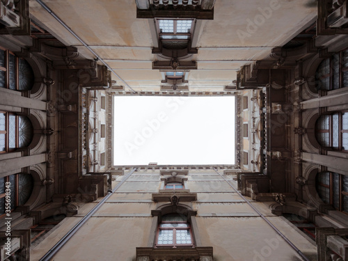 Looking up at the sky in a courtyard of the Palazzo ca Rezzonico, Venice, Italy photo