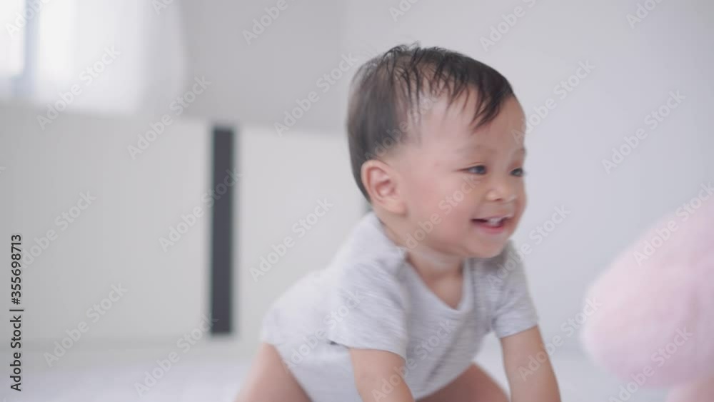 Happy little baby boy crawling on the bed, Kids playing and Happiness concept Happy little baby boy crawling on the bed, Kids playing and Happiness concept