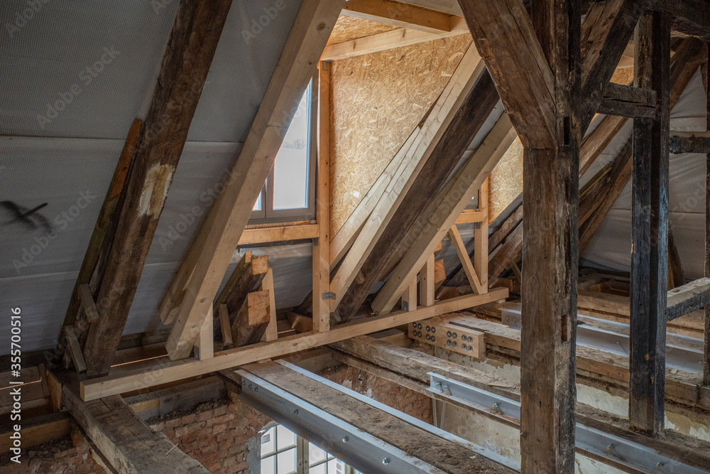 some new wooden dormers are installed in an old half-timbered house