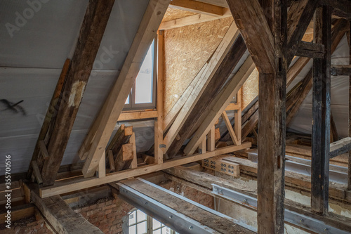 some new wooden dormers are installed in an old half-timbered house