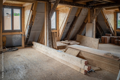 some new wooden dormers are installed in an old half-timbered house