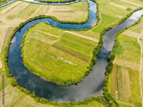 Aerial view of river Lika meandering through Donji Kosinj and Lipovo Polje villages in Croatia. photo