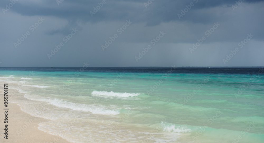 Cloudy landscape of Indian ocean sandy beach before the storm.ZANZIBAR - TANZANIA Cloudy landscape of Indian ocean sandy beach before the storm.ZANZIBAR - TANZANIA