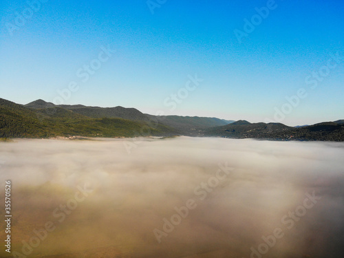 Aerial view of foggy sunrise in Donji Kosinj, Croatia