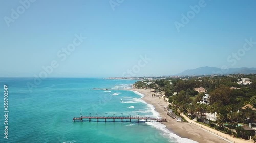 Puente Romano bridge in exclusive area of Marbella. Golden mile view of Nagueles Beach. Drone going forward , near the wood bridge. Empty location due corona virus pandemic, normally full of tourists