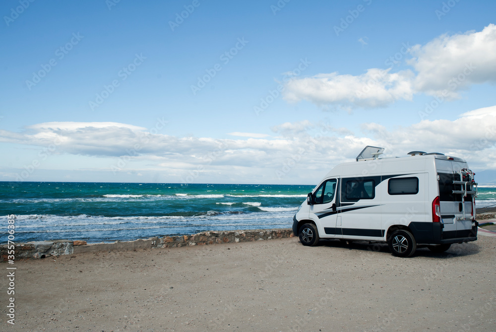 Camping on the beach. Holidays Camper Van.mar and blue sky in the background