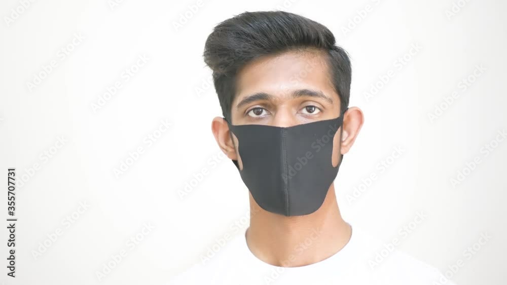 Young Asian boy wearing black surgical mask, man hand gesture, doctors thumbs up, boy thumbs up hand pose, boy thumbs up, young doctor thumbs up, blurred background, selective focus Young Asian boy wearing black surgical mask, man hand gesture, doctors thumbs up, boy thumbs up hand pose, boy thumbs up, young doctor thumbs up, blurred background, selective focus