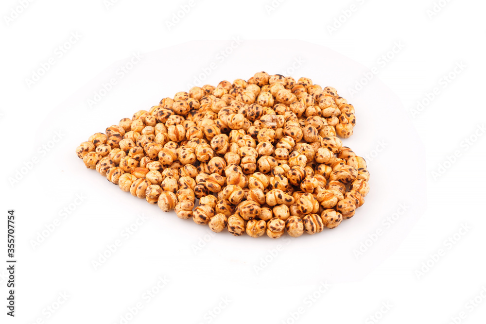 Organic yellow chickpea in heart shape on white background Organic yellow chickpea in heart shape on white background