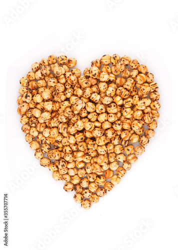 Heart shaped organic chickpeas on a white background