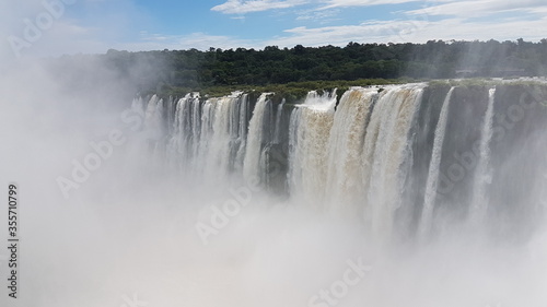 photograph of the famous  grandiose and mighty Iguazu Falls  which give off magical water vapor  seen from the Brazilian side