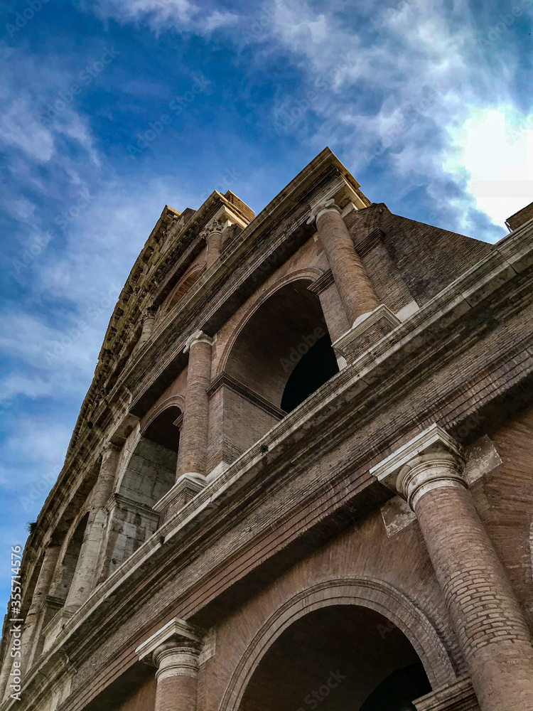 historical roman empire colosseum with blue sky dramatic rome