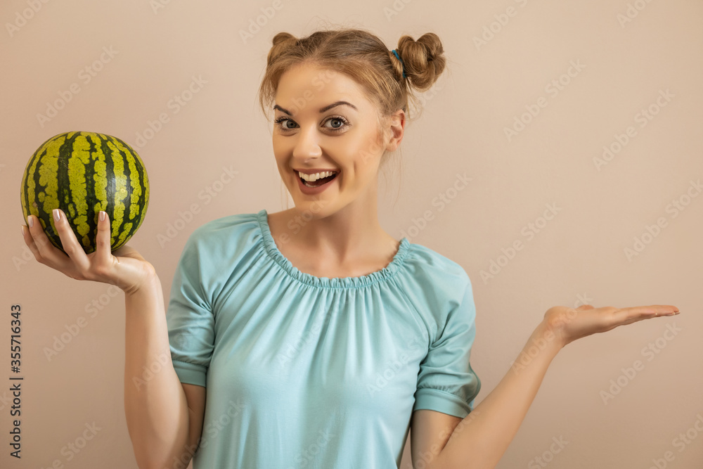Cute playful woman holding watermelon and gesturing.Toned image. Cute playful woman holding watermelon and gesturing.Toned image.