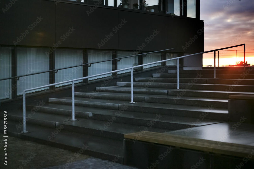 Fototapeta premium empty staircase and modern business office building, sunset sky