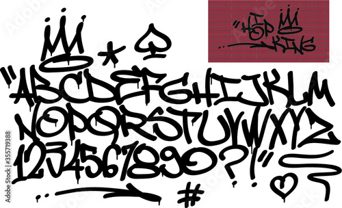 Spray graffiti tagging font and signs (crown, heart, star, arrow, dot, quotation mark, number, spade). ''Hip-hop king'' quote on brick wall background.