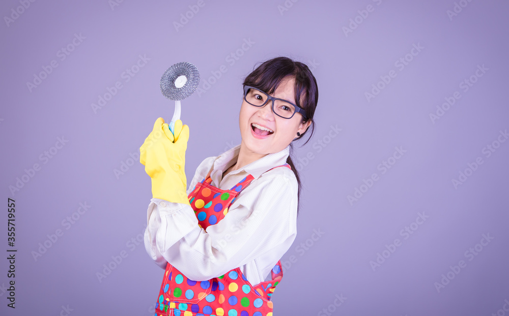 Asian Woman cleaning and polishing the kitchen worktop with a spray detergent, housekeeping and hygiene concept, accessories studio shot isolated on Gray background Asian Woman cleaning and polishing the kitchen worktop with a spray detergent, housekeeping and hygiene concept, accessories studio shot isolated on Gray background