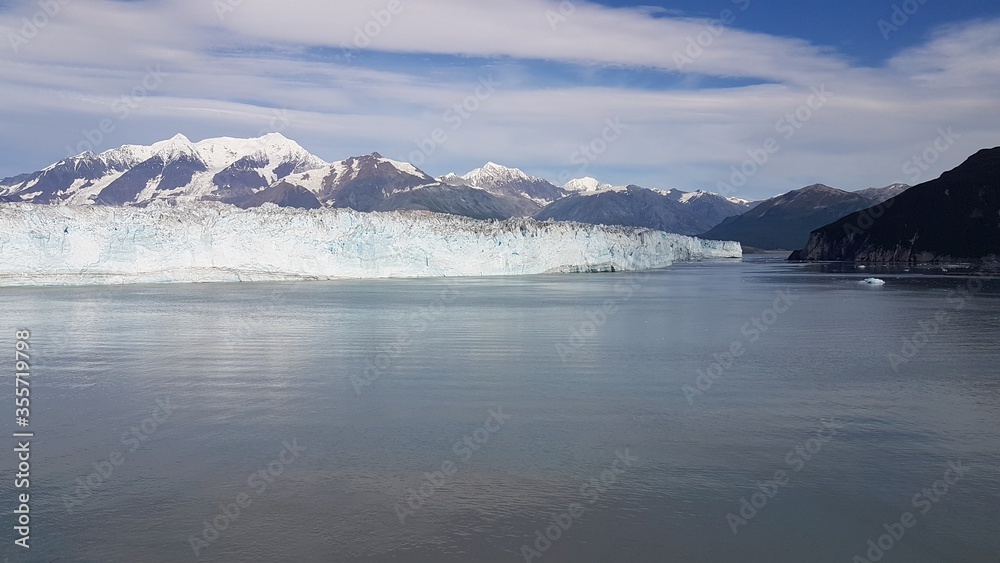 Aesthetic photography of the famous Argentine glacier, the Perito Moreno, with a unique composition and reflections of the high mountains of the Andes on the water