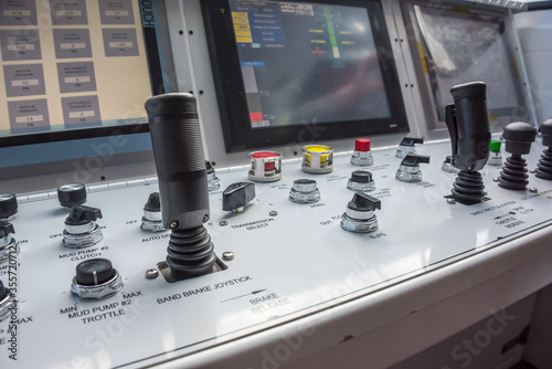 Oil rig computer controls & switches in operators room on rig floor.