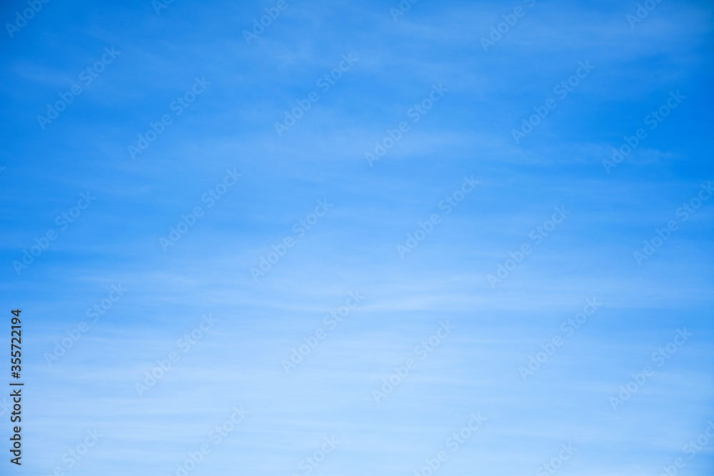 Blue sky with smooth clouds background.