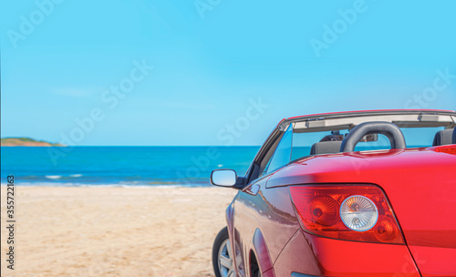 Red car on the beach. Cars on the beach. Vacation and freedom concept.