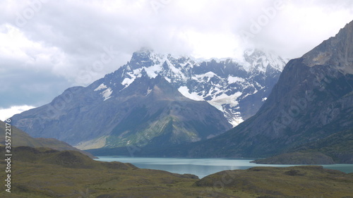 images of the Argentine mountains of the Andes, crowned with snow and clouds that make them mystical, and at their feet green fields and a lake