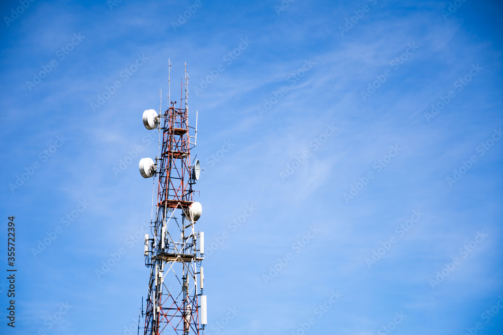 Telecommunication tower wireless technology against blue sky and clouds. Telecommunication tower wireless technology against blue sky and clouds.
