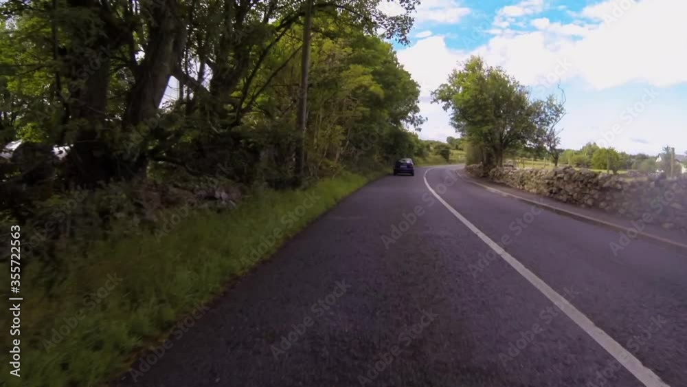 POV time lapse shot of vehicles on street amidst plants against sky - Galway, Ireland POV time lapse shot of vehicles on street amidst plants against sky - Galway, Ireland