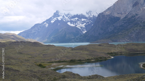 images of the Argentine mountains of the Andes, crowned with snow and clouds that make them mystical, and at their feet green fields and a lake