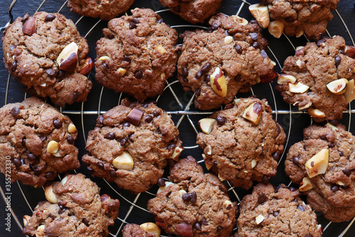 Photography of homemade cookies on cooling grid on slate background for food illustrations photo