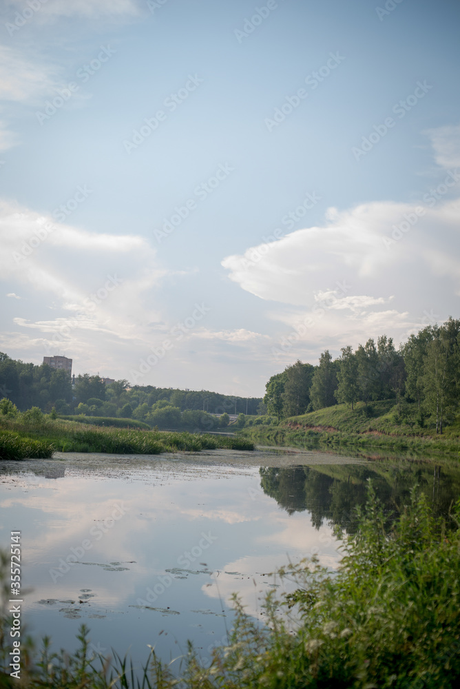 summer sky, green grass and trees, river