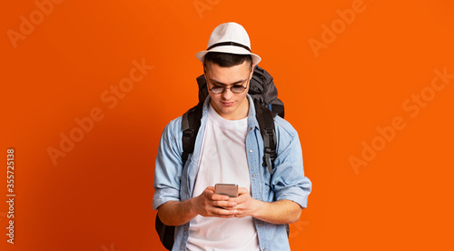 Young man backpacker using mobile phone app for travelers © Prostock-studio