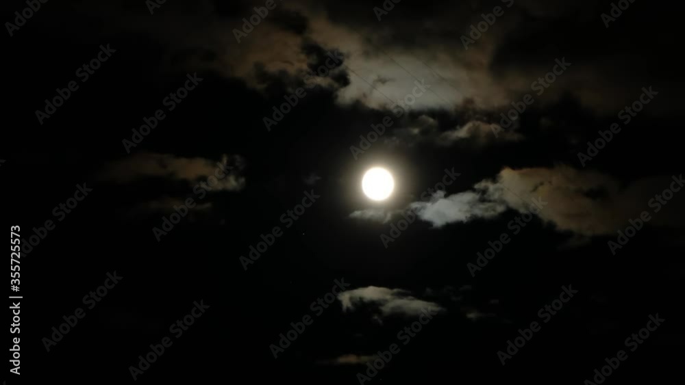 Beautiful shot with full moon and fast running clouds Beautiful shot with full moon and fast running clouds