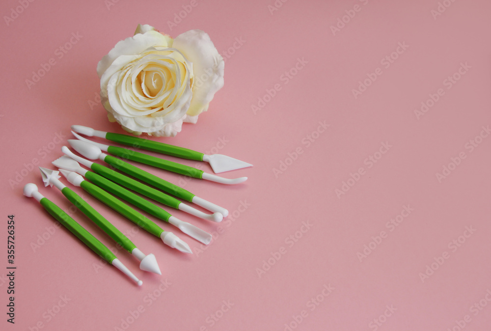 set for pastry chef when preparing a cake, plastic set for mastic on a pink background set for pastry chef when preparing a cake, plastic set for mastic on a pink background