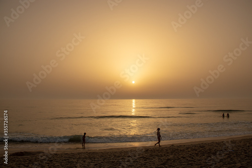 children's playing at sunset in Mira beach , Portugal Ocean atlantic sunset