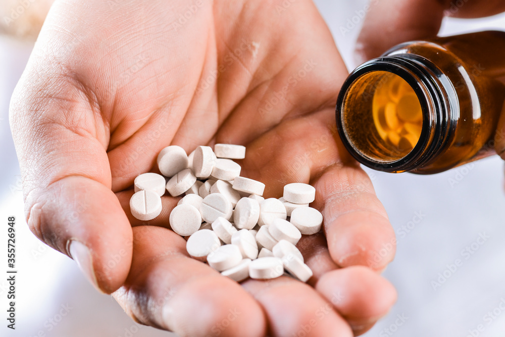 Man hand holding on open palm with pill tablets medicine for healing. Man hand holding on open palm with pill tablets medicine for healing.