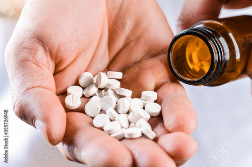 Fototapete Man hand holding on open palm with pill tablets medicine for healing