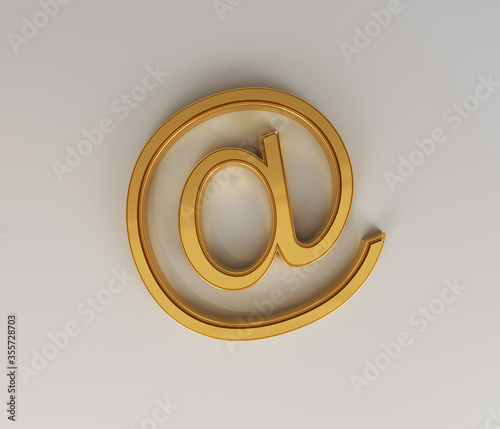 Golden At sign with soft shadows on a white background. 