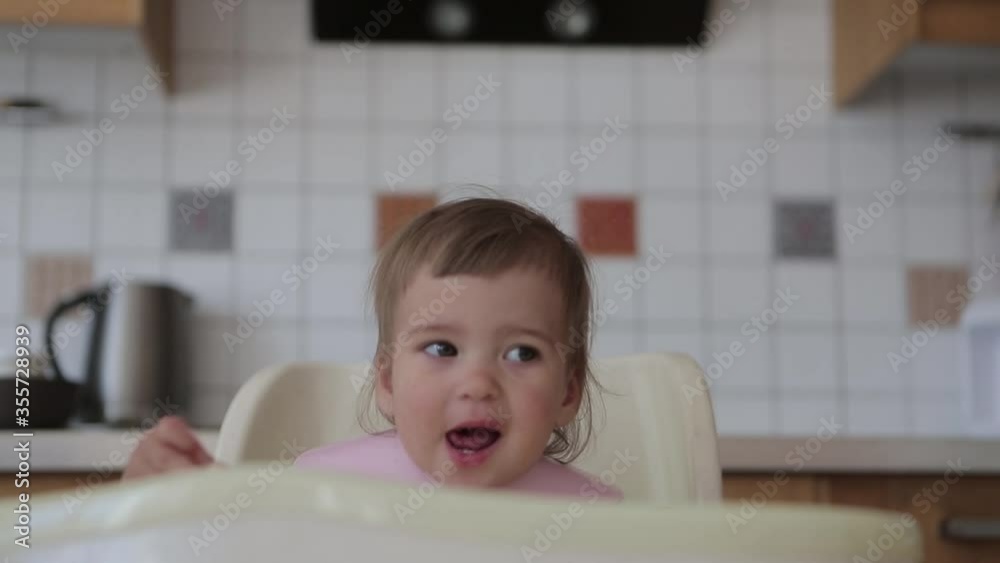 portrait of a child who eats baby food with his hands portrait of a child who eats baby food with his hands