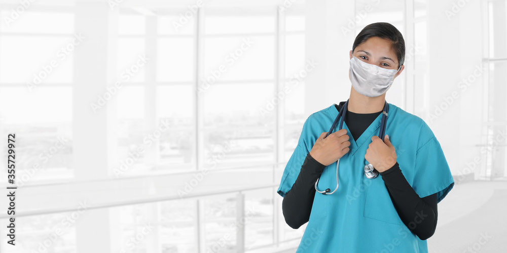 Young woman nurse or doctor holding stethoscope draped around her neck with a blurry modern medical facility background, with copy space. Young woman nurse or doctor holding stethoscope draped around her neck with a blurry modern medical facility background, with copy space.
