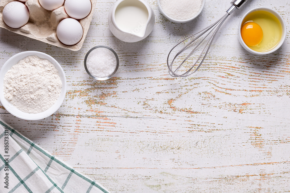 Ingredients for baking - flour, eggs, salt, sugar, milk. Ingredients for baking - flour, eggs, salt, sugar, milk.