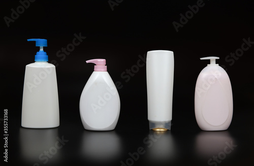 Variety shpae of liquid bottle on black background, plastic bottles of body care and beauty products on Black background photo