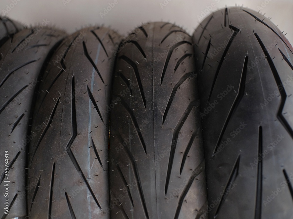 Motorcycle tires with a variety of motives in an automotive workshop Motorcycle tires with a variety of motives in an automotive workshop
