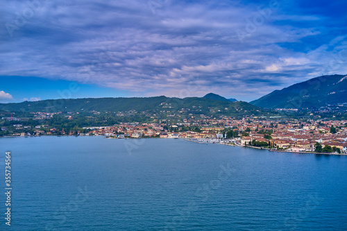 High Altitude Coastline Panorama. Aerial view of the city of Salò, Lake Garda, Italy. 