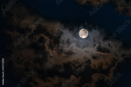 Full Moon peaking through beautiful cloudscape