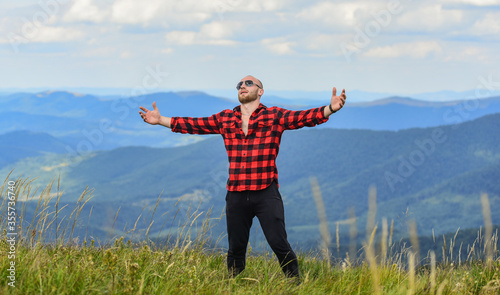 powerful and free. cowboy outdoor. man on mountain landscape. camping and hiking. countryside concept. farmer on rancho. travelling adventure. hipster fashion. sexy macho man in checkered shirt