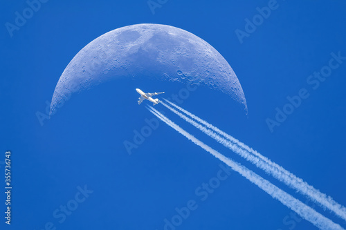 Passenger plane - airliner passes near the moon. Explore new frontier. Space traveler concept