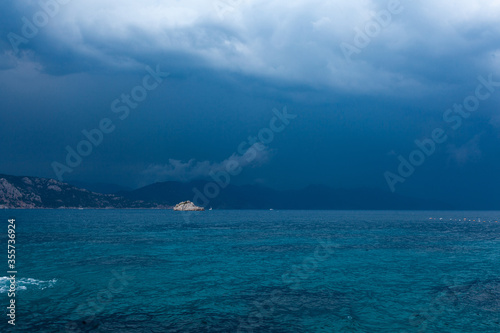 Blue sea and clouds in a blue stormy sky